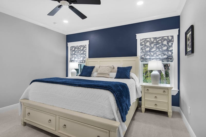Close view of bed and nightstand in modern bedroom in The Lafon custom home by EZ Modern Homes Pensacola, FL-optimized
