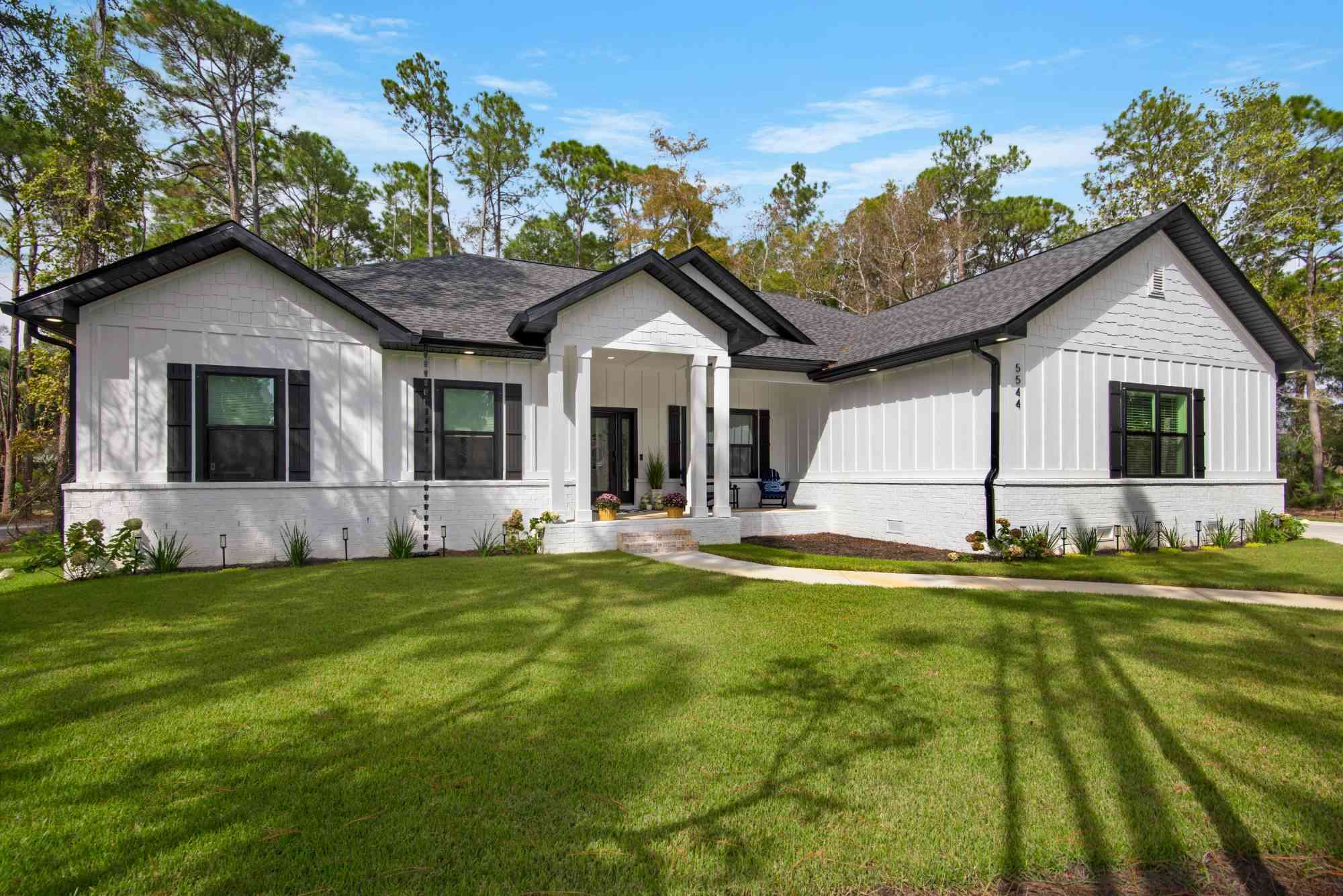 close view of custom home front porch with columns and seating by EZ Modern Homes Pensacola FL The Lafon-optimized-optimized