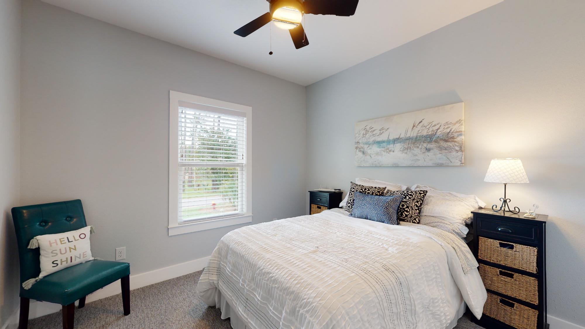 cozy bedroom with neutral decor and ceiling fan by EZ Modern Homes custom home in Pensacola FL The Lafon-optimized