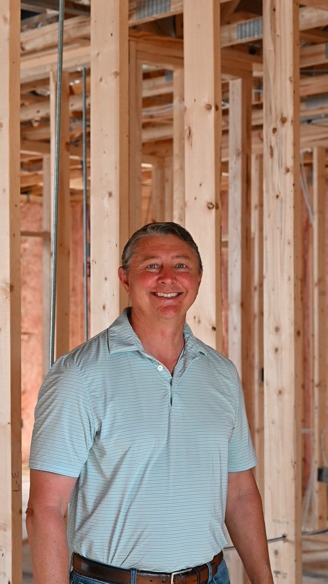 John Kyzer construction expert inside custom home framing by EZ Modern Homes Pensacola FL-optimized