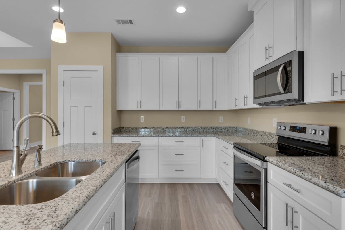 close-up of granite countertops and white cabinetry in Pensacola FL custom home by EZ Modern Homes The Poderosa-optimized