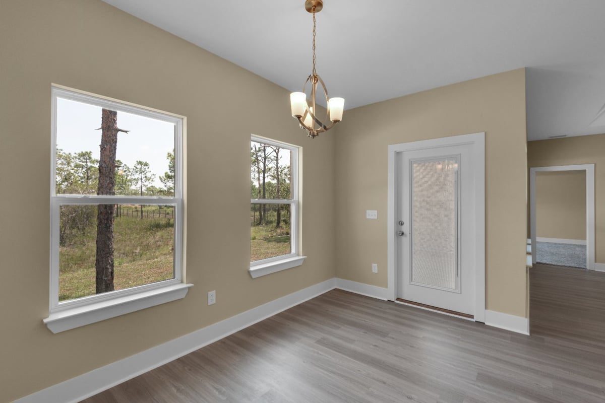 dining area and back door in custom home The Poderosa by EZ Modern Homes Pensacola FL-optimized