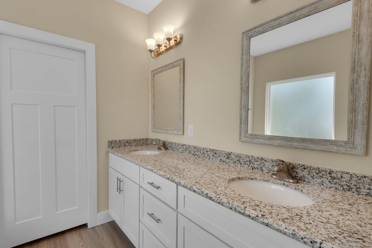 double vanity bathroom with granite countertop in Pensacola FL custom home by EZ Modern Homes The Poderosa-optimized