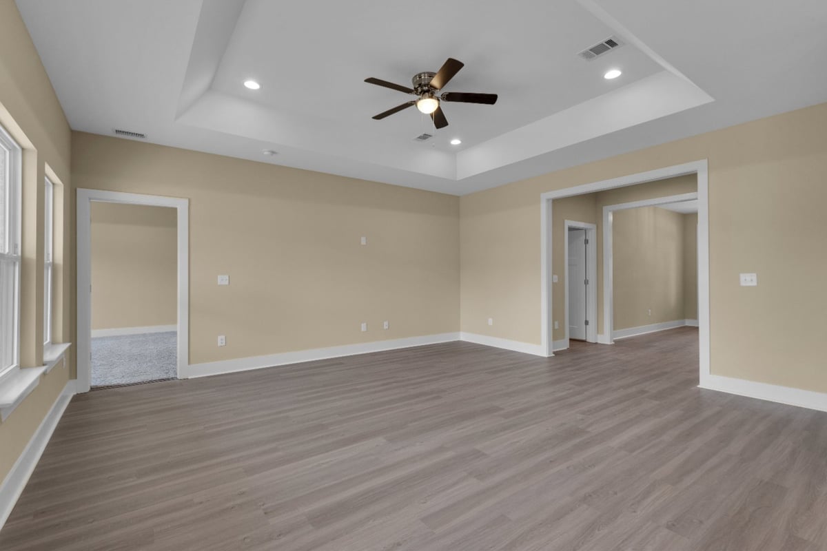 interior living area with tray ceiling design The Poderosa by EZ Modern Homes Pensacola FL-optimized