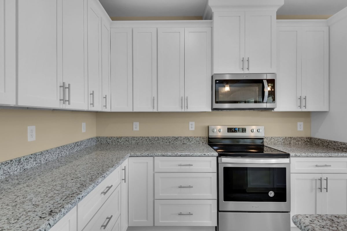 kitchen wall with built-in microwave and white cabinetry in EZ Modern Homes custom home Pensacola FL The Poderosa-optimized