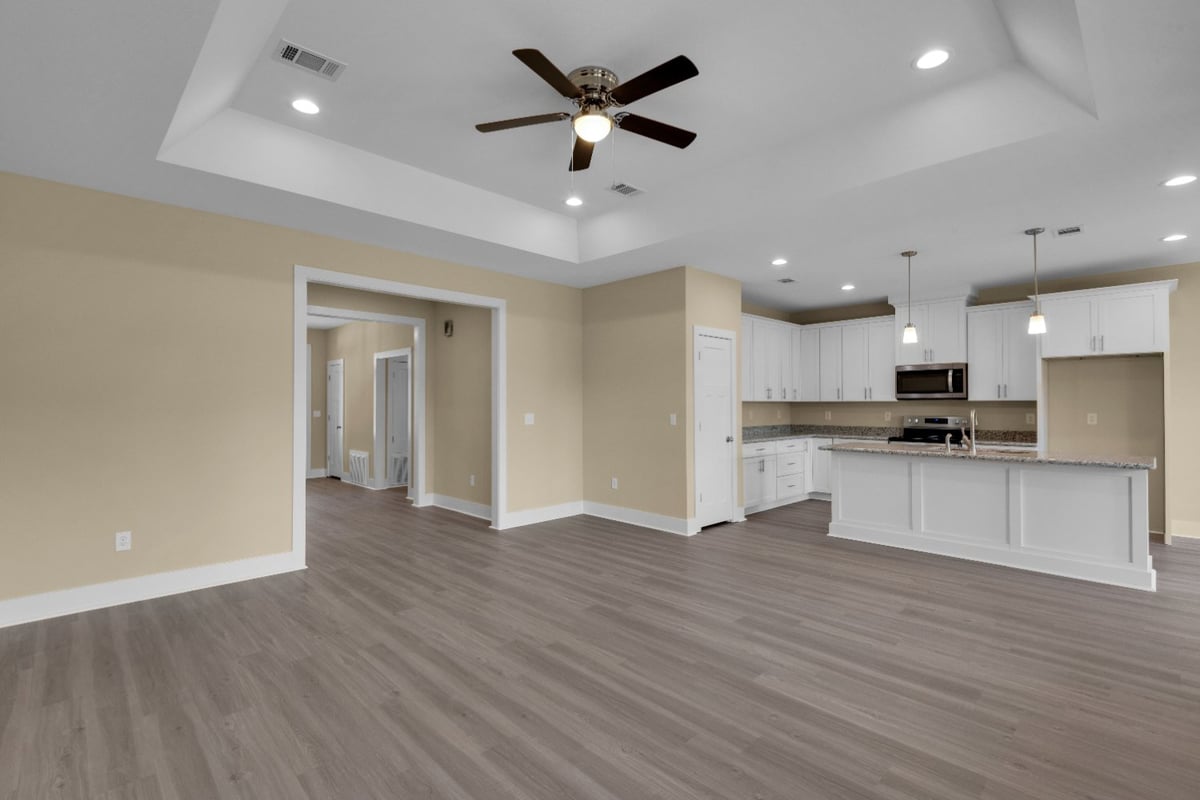 open concept living and kitchen area in custom home The Poderosa by EZ Modern Homes Pensacola FL-optimized