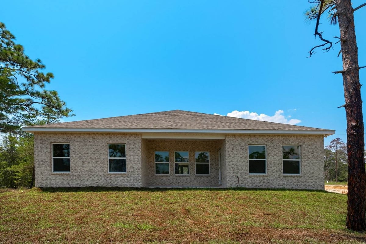 rear exterior view of brick custom home The Poderosa by EZ Modern Homes in Pensacola, FL-optimized-optimized