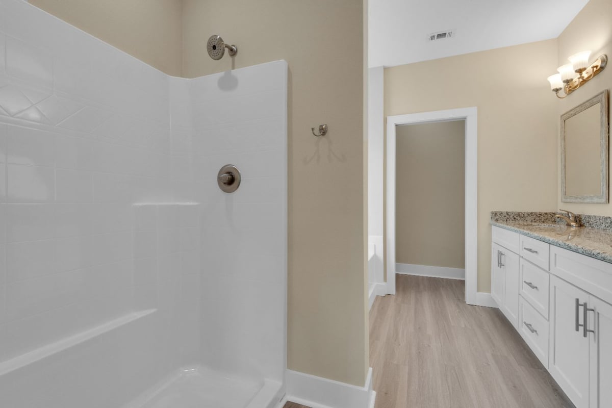 shower and vanity area in modern bathroom in Pensacola FL custom home by EZ Modern Homes The Poderosa-optimized