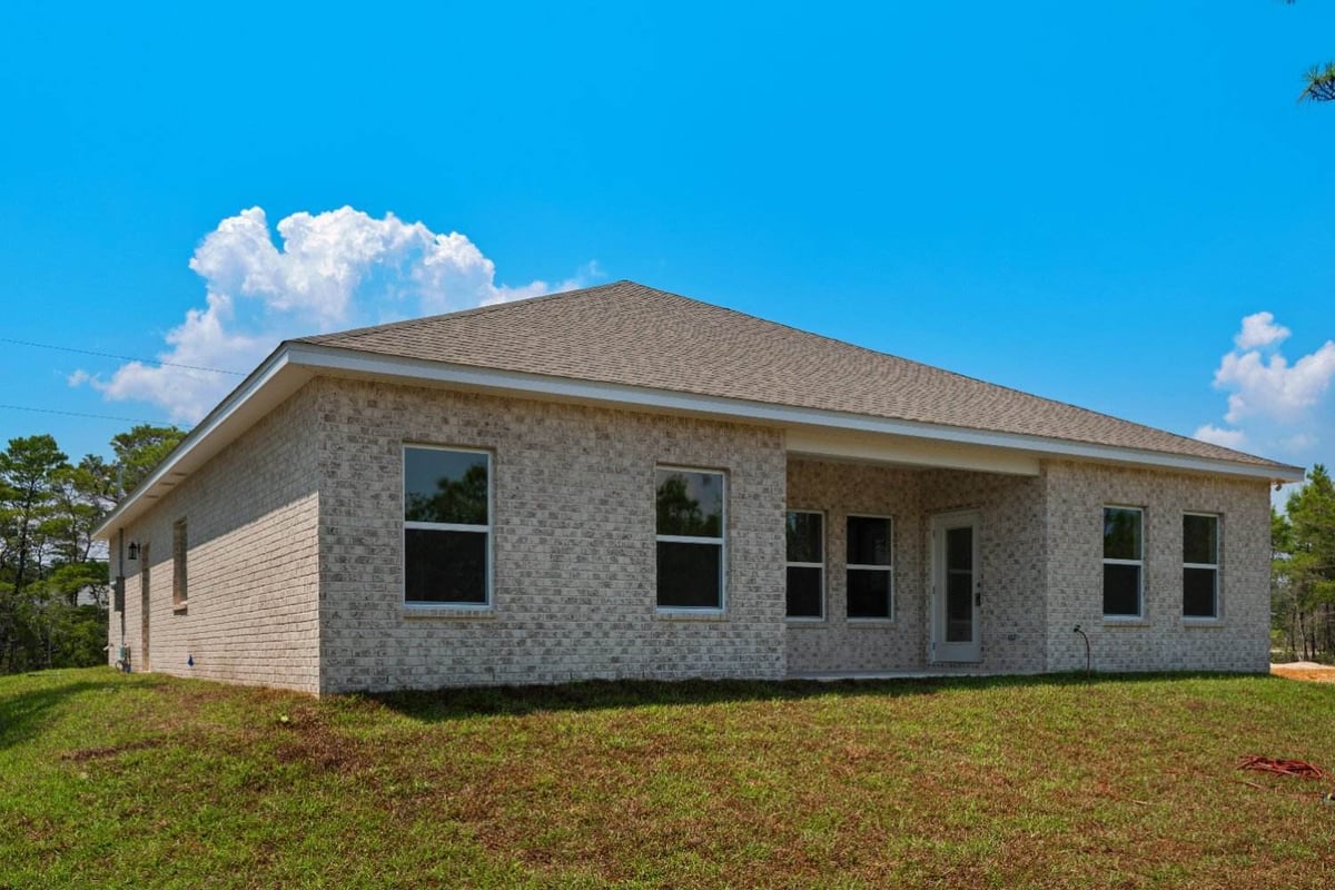 side and backyard view of Pensacola, FL custom home by EZ Modern Homes The Poderosa-optimized-optimized