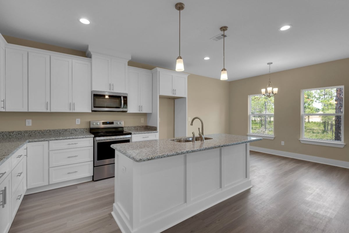 spacious kitchen with large island and natural light in EZ Modern Homes custom home Pensacola FL The Poderosa-optimized