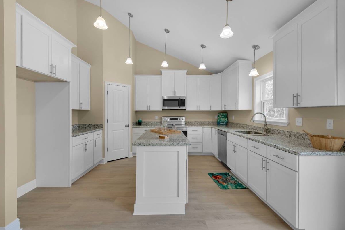 Center island kitchen with stainless steel appliances by EZ Modern Homes Pensacola FL The Pins-optimized