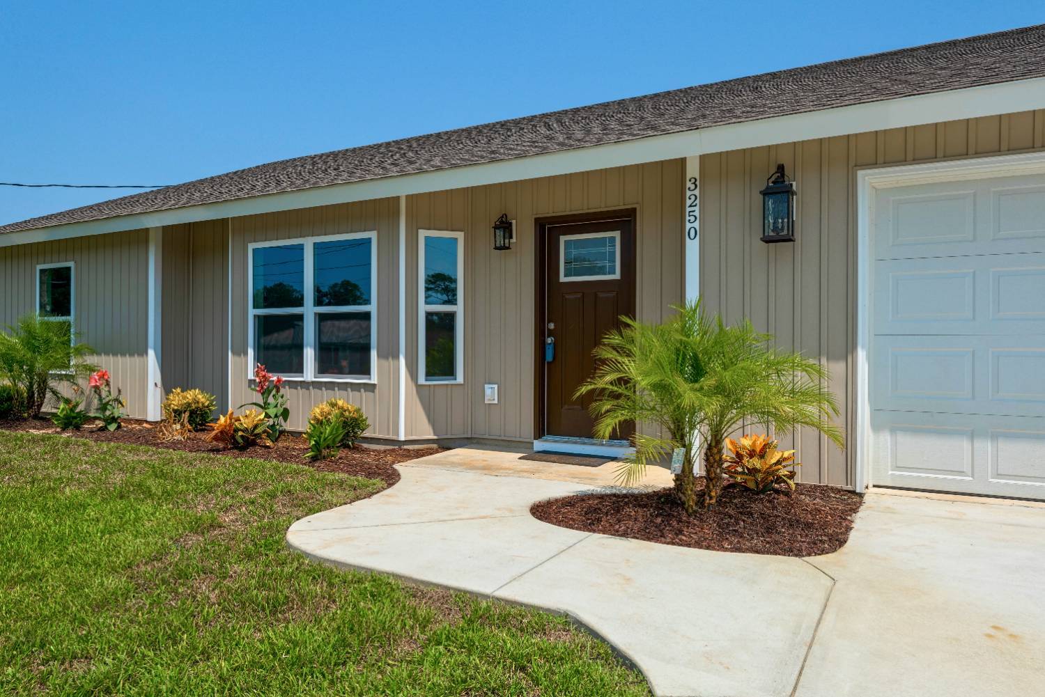 Close-up of entry door and garden bed in Pensacola FL custom home The Pins-optimized