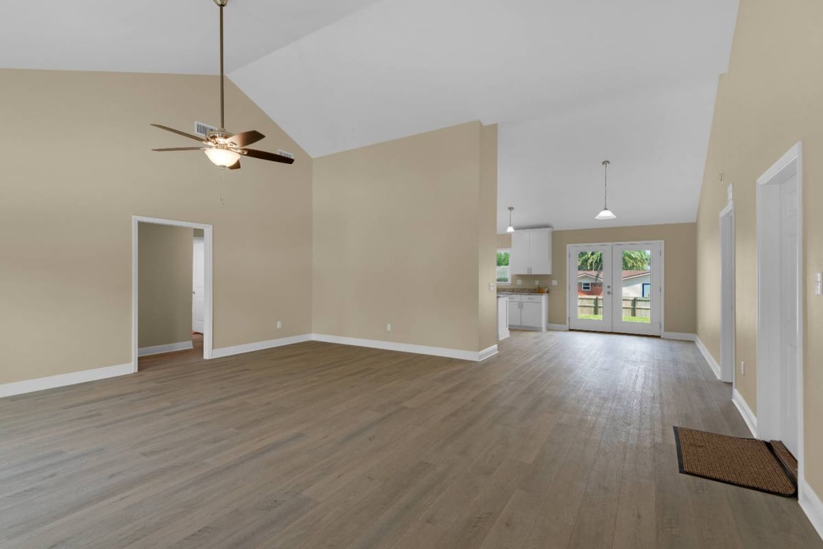 Open concept living room with vaulted ceilings in custom home by EZ Modern Homes Pensacola FL The Pins-optimized