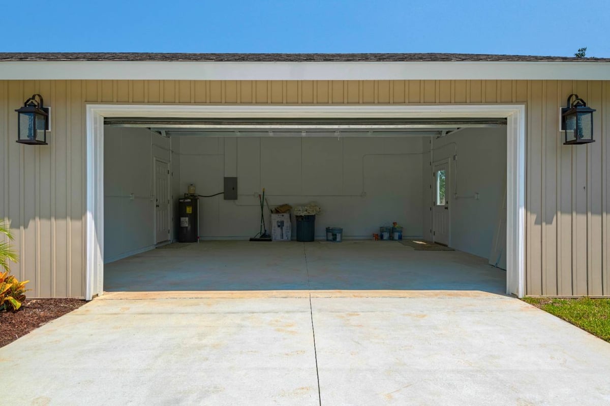 open two-car garage exterior with wide driveway in custom home by EZ Modern Homes in Pensacola, FL-optimized