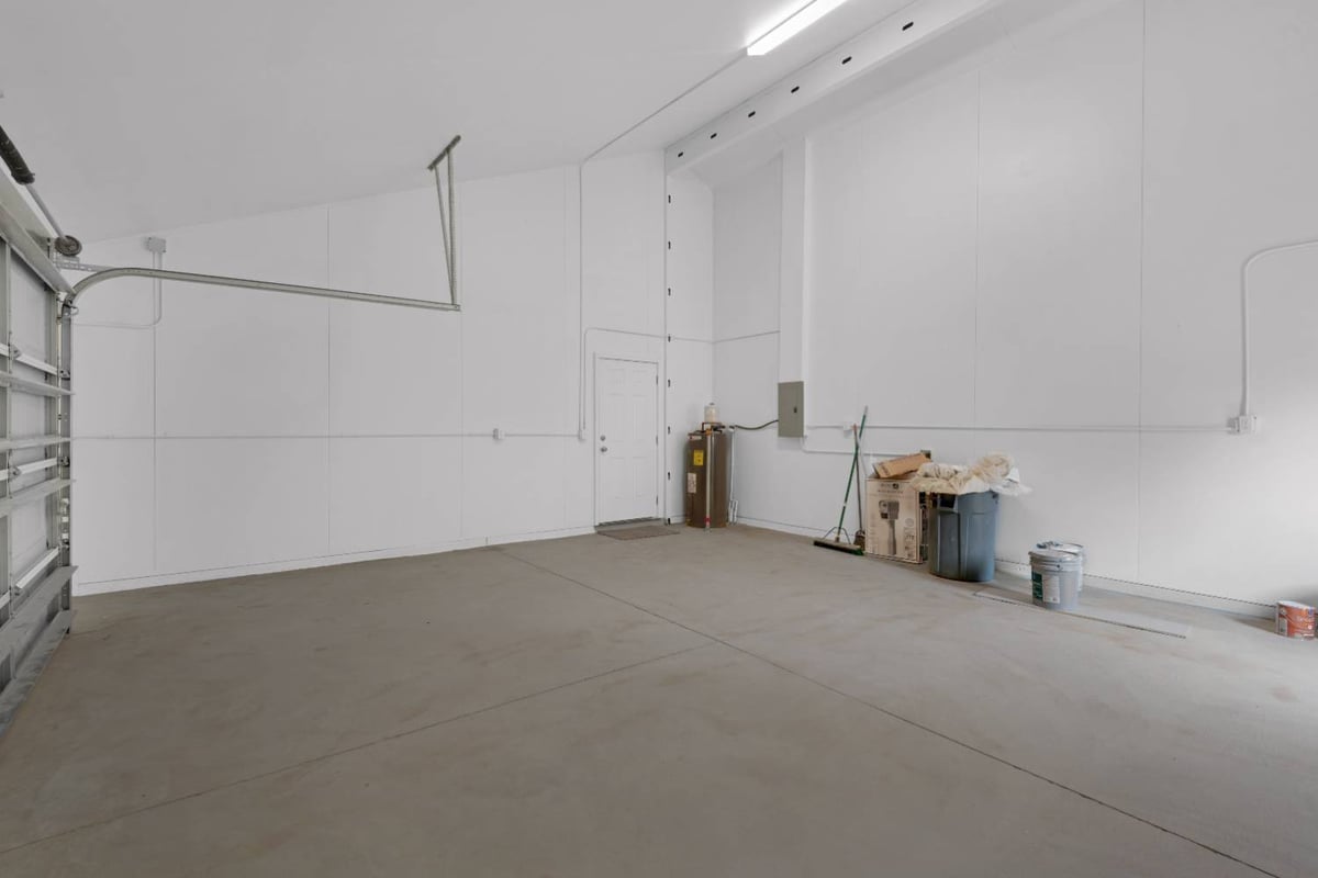 wide garage interior with high ceilings and utility access in custom home by EZ Modern Homes in Pensacola, FL-optimized