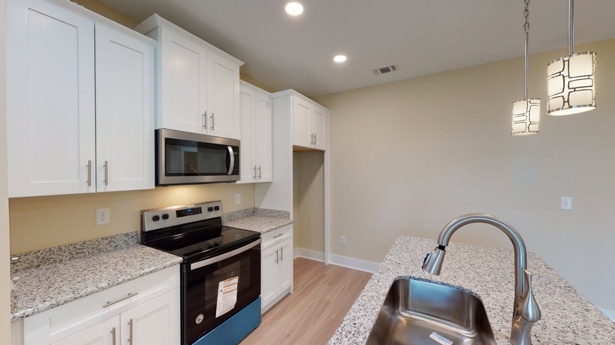 Interior kitchen space of a Pensacola, FL custom home by EZ Modern Homes with clean design and lighting.-optimized