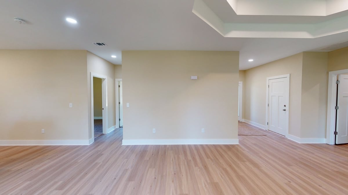 Interior view of open floor plan in a custom home by EZ Modern Homes in Pensacola, FL highlighting multiple rooms.-optimized