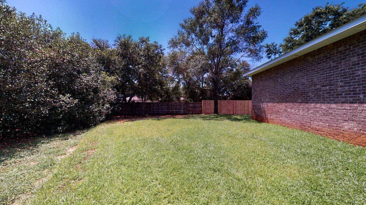backyard elevation showing patio and lawn in EZ Modern Homes Pensacola FL custom home The Abilene-optimized-optimized