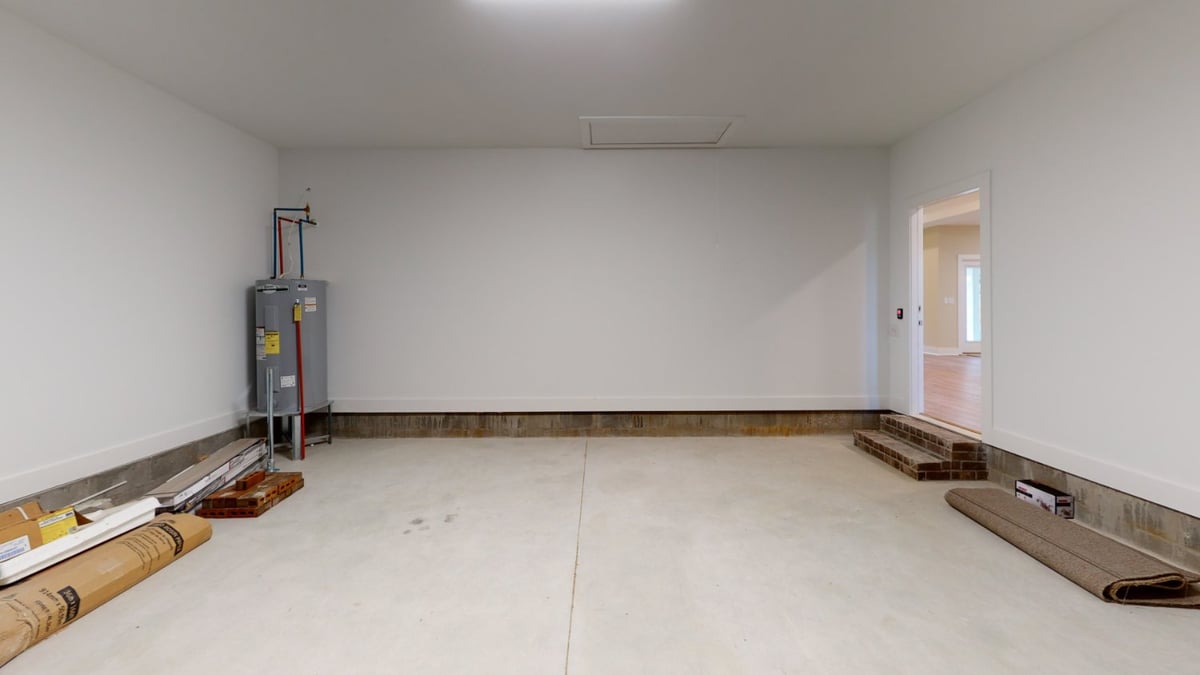 clean two car garage with concrete floor by EZ Modern Homes Pensacola FL custom home The Abilene-optimized