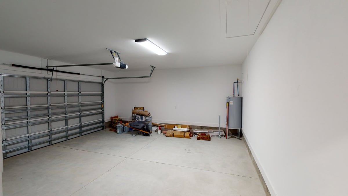 large garage with overhead door and storage items by EZ Modern Homes custom home Pensacola FL The Abilene-optimized