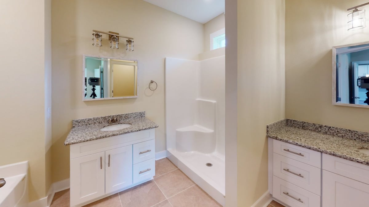 modern bathroom layout with granite counters and shower in Pensacola, FL custom home by EZ Modern Homes-optimized