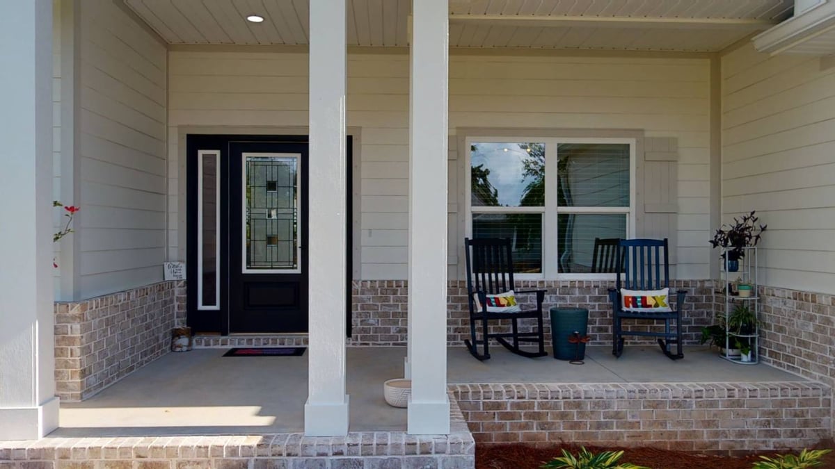 Close-up of EZ Modern Homes The Lafon custom home front door and porch seating in Pensacola, FL-optimized