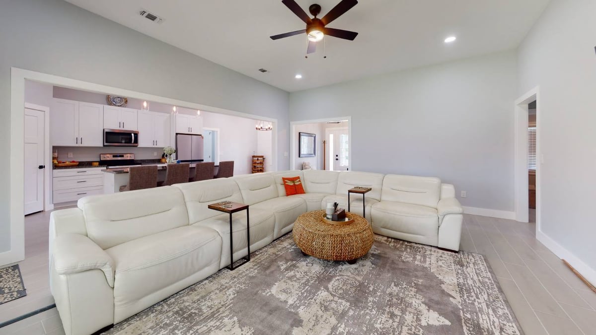 Cozy living room of EZ Modern Homes custom home The Lafon with modern decor in Pensacola, FL-optimized