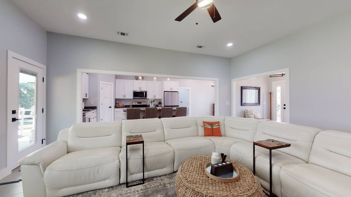 Open living room and kitchen view in EZ Modern Homes The Lafon custom home in Pensacola, FL-optimized