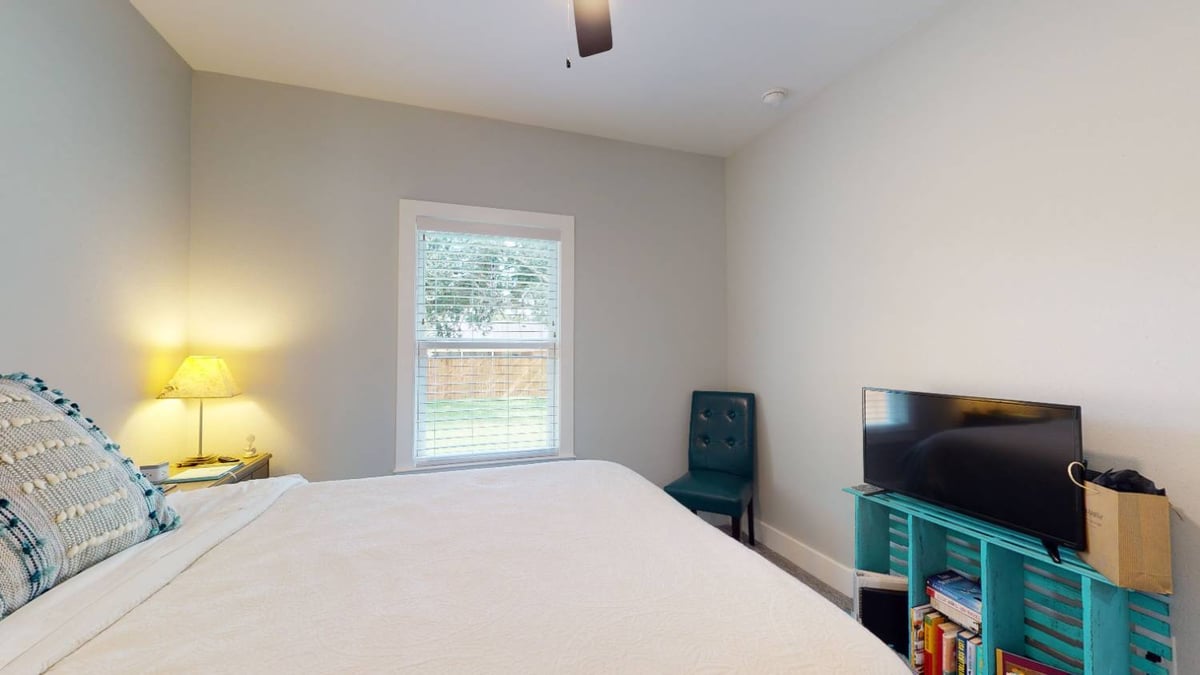 bedroom with TV stand and seating area by EZ Modern Homes custom home in Pensacola FL The Lafon-optimized
