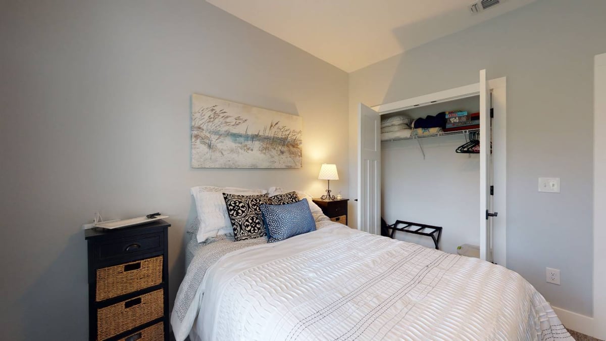 bedroom with closet and decorative wall art by EZ Modern Homes custom home in Pensacola FL The Lafon-optimized