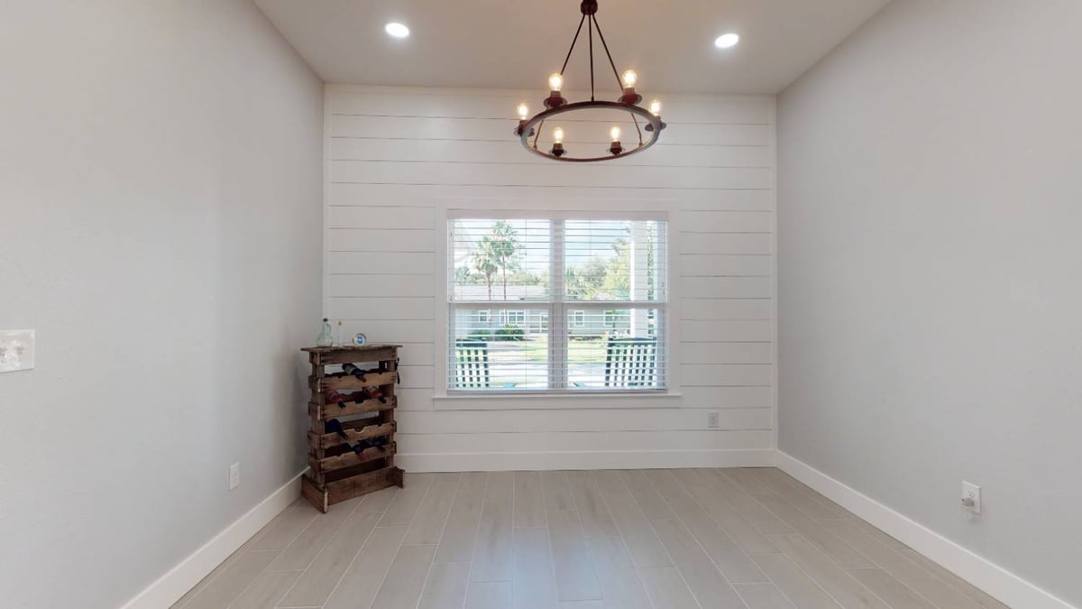 dining nook with chandelier and shiplap wall in The Lafon custom home by EZ Modern Homes in Pensacola, FL-optimized