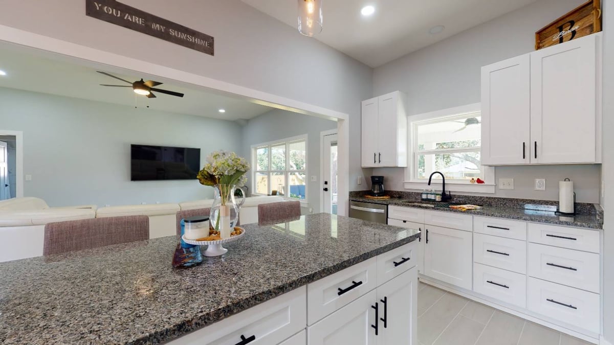kitchen island overlooking living room in The Lafon custom home by EZ Modern Homes in Pensacola, FL-optimized