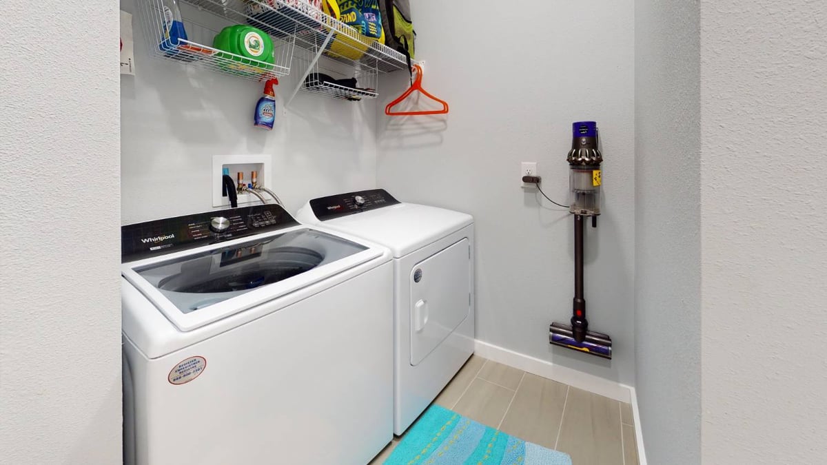 laundry room with washer and dryer setup by EZ Modern Homes custom home in Pensacola FL The Lafon-optimized