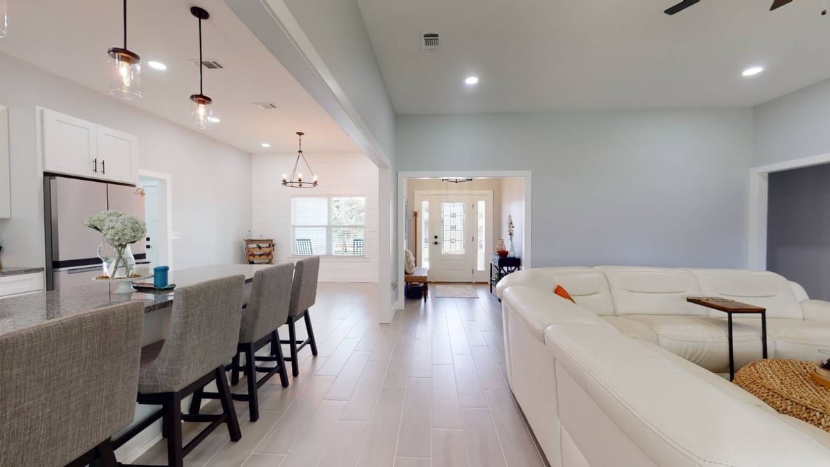 modern open-concept kitchen and living area in The Lafon custom home by EZ Modern Homes in Pensacola, FL-optimized