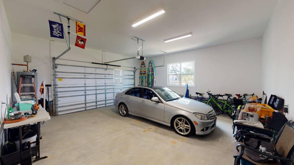 two car garage interior with vehicle and storage space by EZ Modern Homes custom home in Pensacola FL The Lafon-optimized