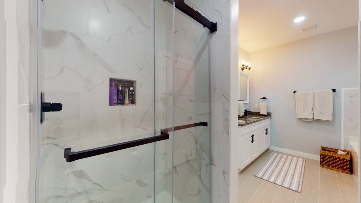 walk-in shower with glass door and tile walls by EZ Modern Homes custom home in Pensacola FL The Lafon-optimized