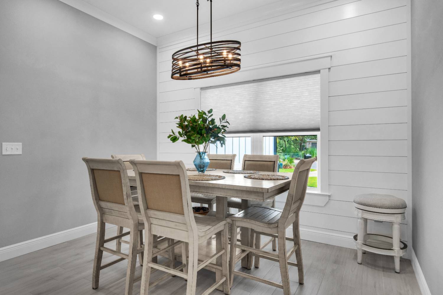 Dining area with wood table and pendant light in The Lafon custom home by EZ Modern Homes Pensacola, FL-optimized