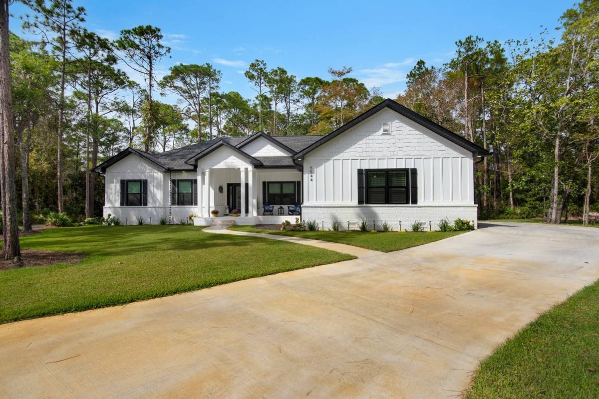 angled front exterior of custom home with long driveway by EZ Modern Homes Pensacola FL The Lafon-optimized