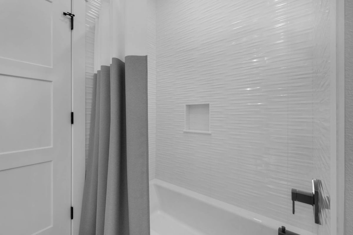 bathtub and tiled shower wall in Pensacola custom home by EZ Modern Homes The Lafon-optimized