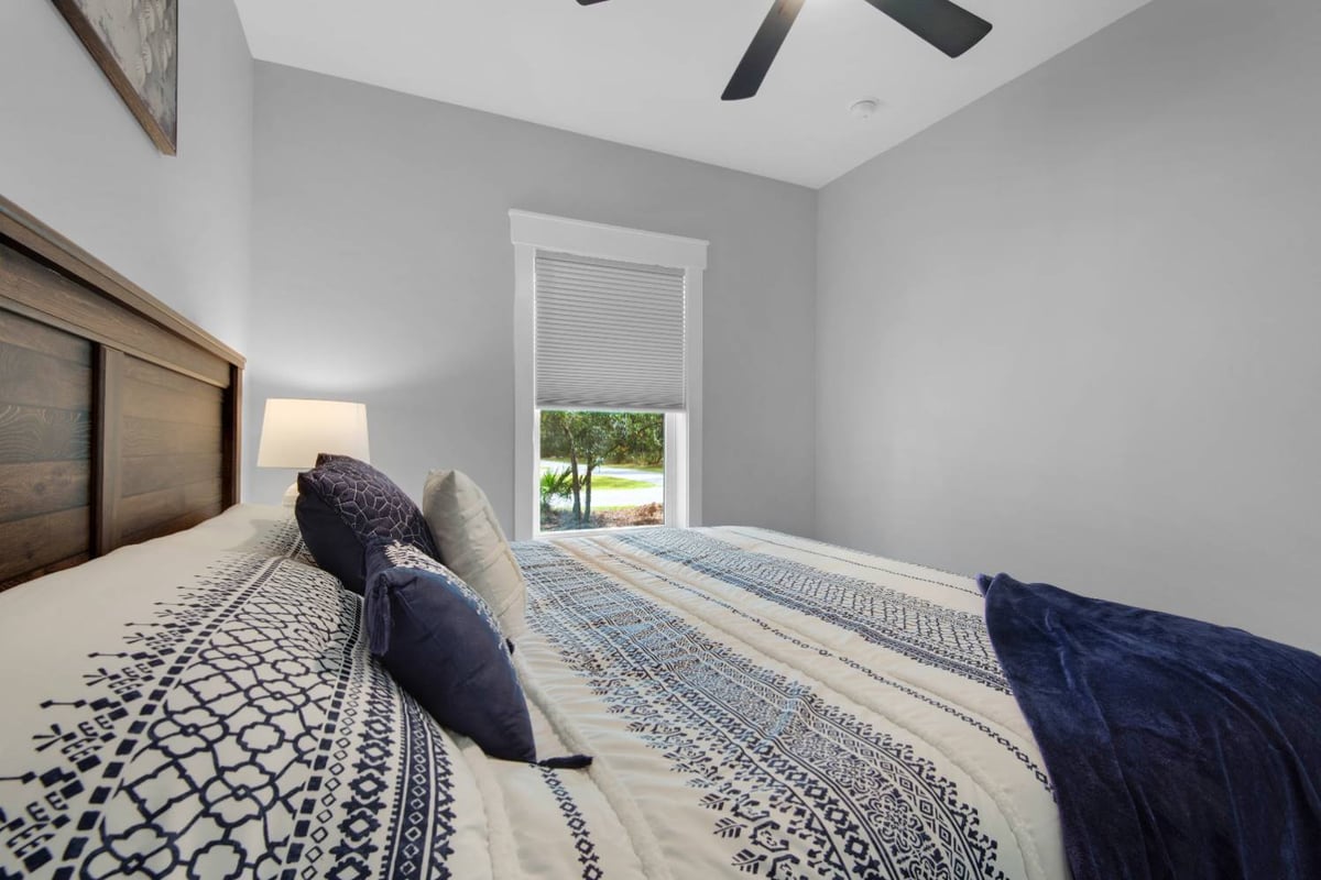 close view of bed and window in modern bedroom by EZ Modern Homes Pensacola FL custom home The Lafon-optimized