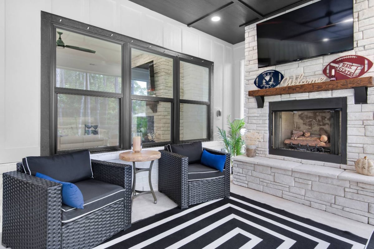 cozy screened porch seating and fireplace in custom home by EZ Modern Homes Pensacola, FL The Lafon-optimized