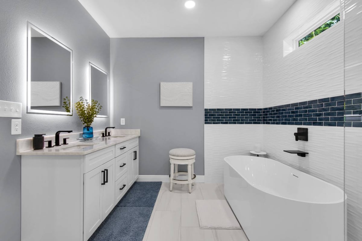 double vanity and soaking tub in modern bathroom by EZ Modern Homes in Pensacola FL custom home The Lafon-optimized