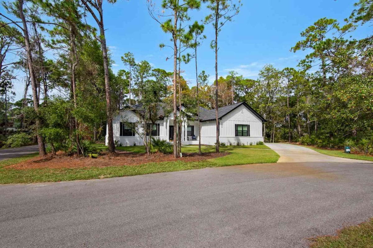 driveway view leading to custom built home with natural landscaping by EZ Modern Homes in Pensacola FL The Lafon-optimized-optimized