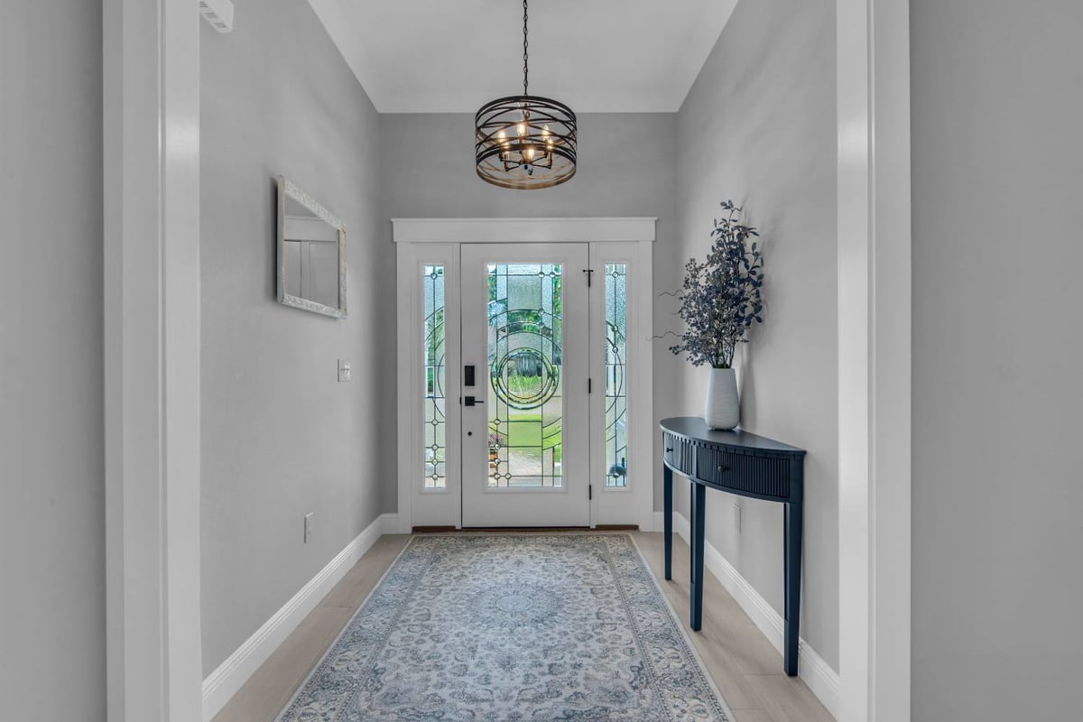 entryway with modern chandelier and glass front door by EZ Modern Homes in Pensacola FL The Lafon-optimized