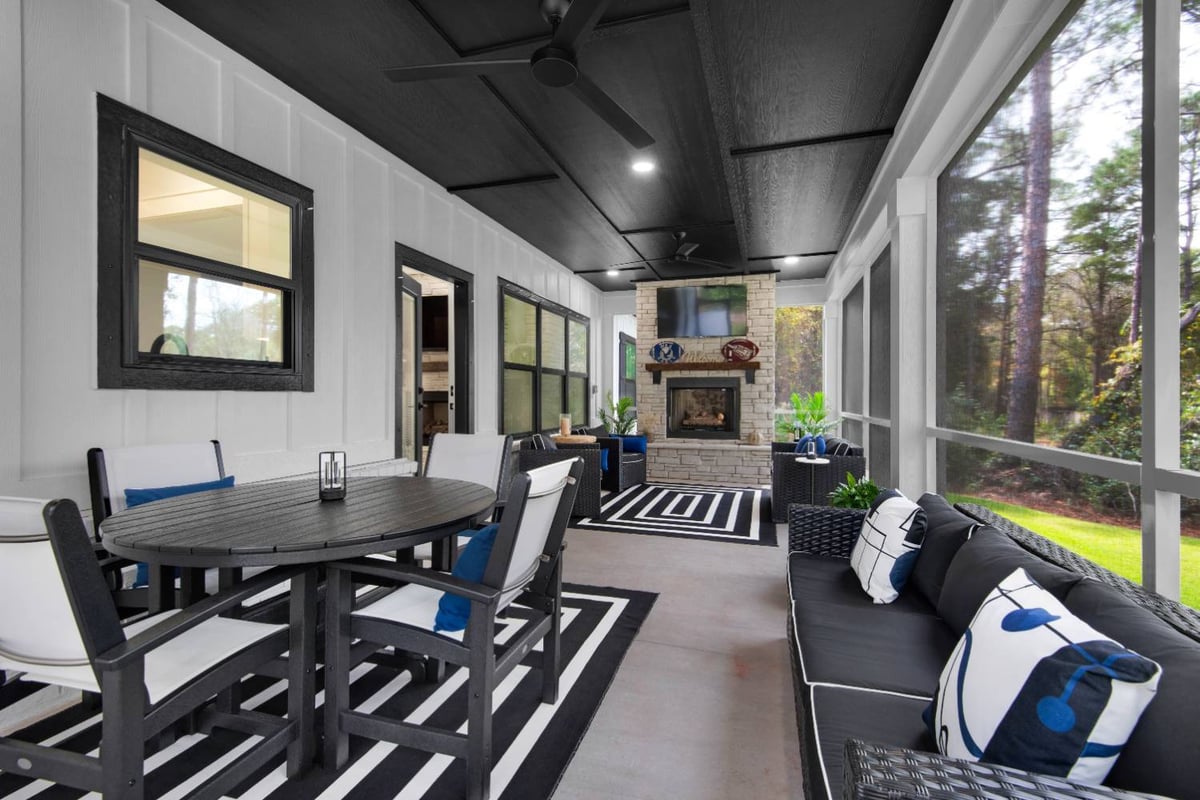 extended screened porch with dining and lounge zones in custom home by EZ Modern Homes Pensacola, FL The Lafon-optimized