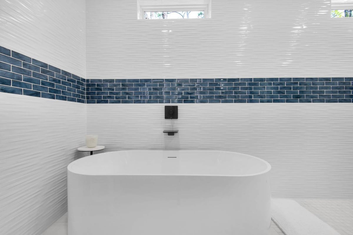 freestanding tub with blue tile accent wall in Pensacola custom home by EZ Modern Homes The Lafon-optimized