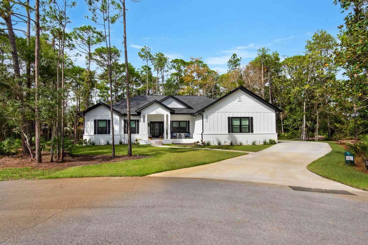 full front elevation of custom home with white siding and black accents by EZ Modern Homes Pensacola FL The Lafon-optimized-optimized