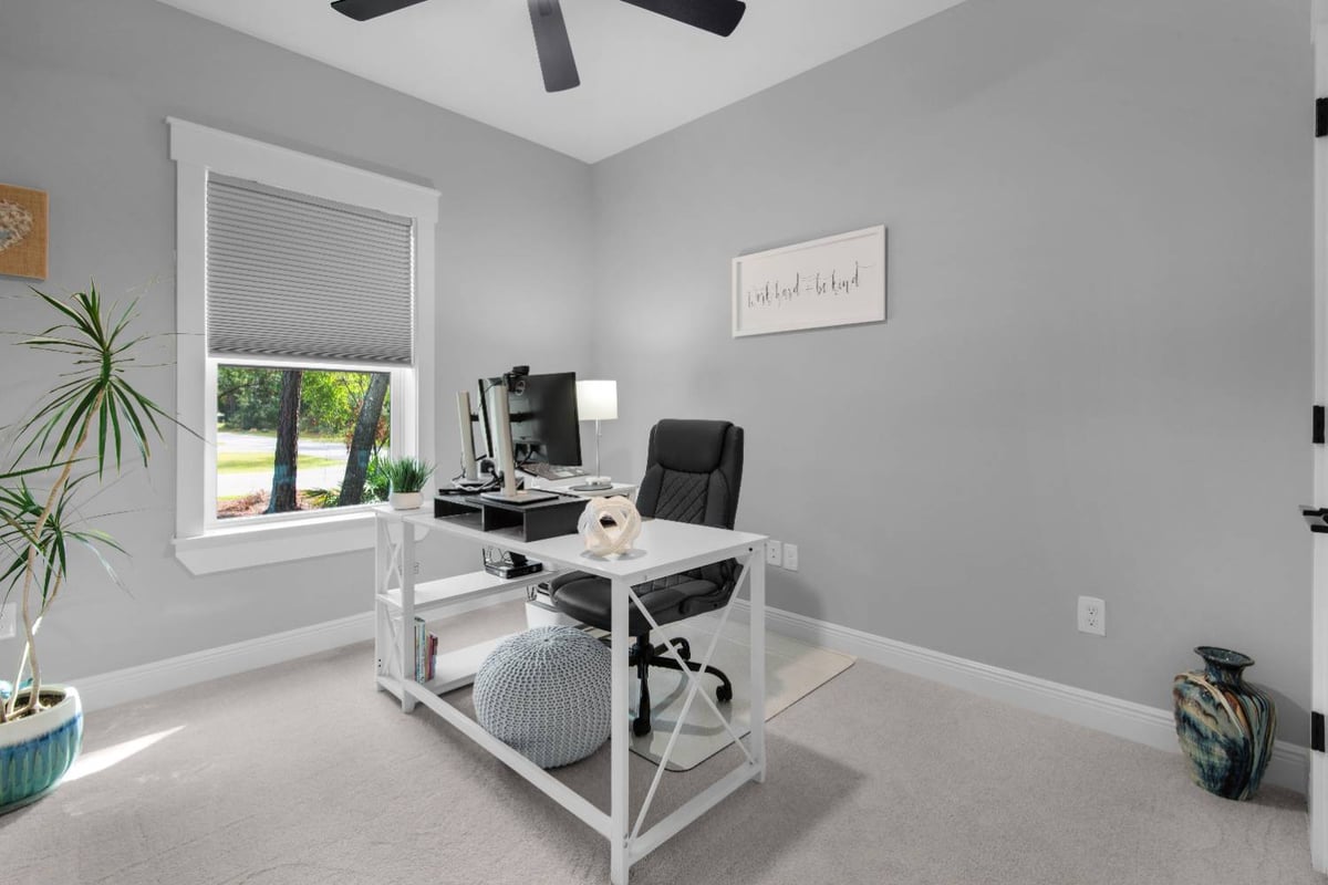 home office with desk and computer setup in Pensacola custom home by EZ Modern Homes The Lafon-optimized