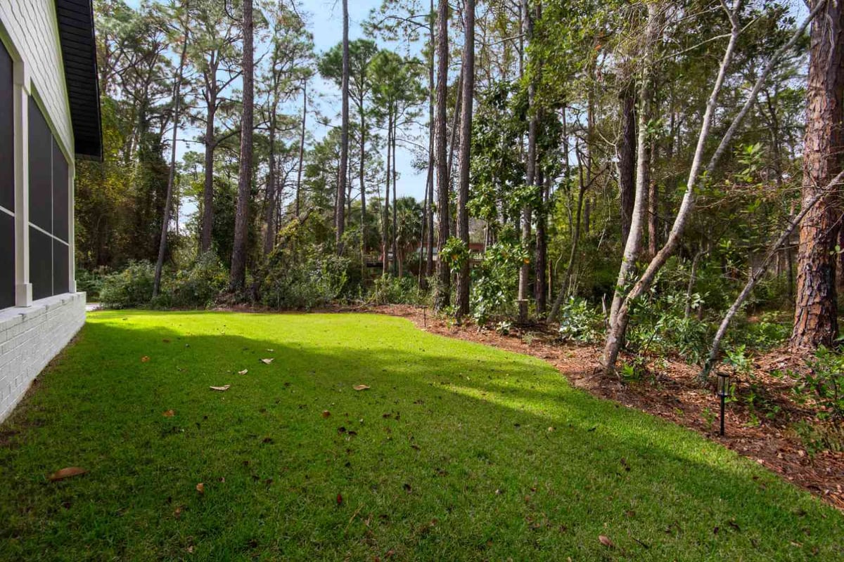 landscaped backyard lawn with trees in custom home by EZ Modern Homes Pensacola, FL The Lafon-optimized-optimized