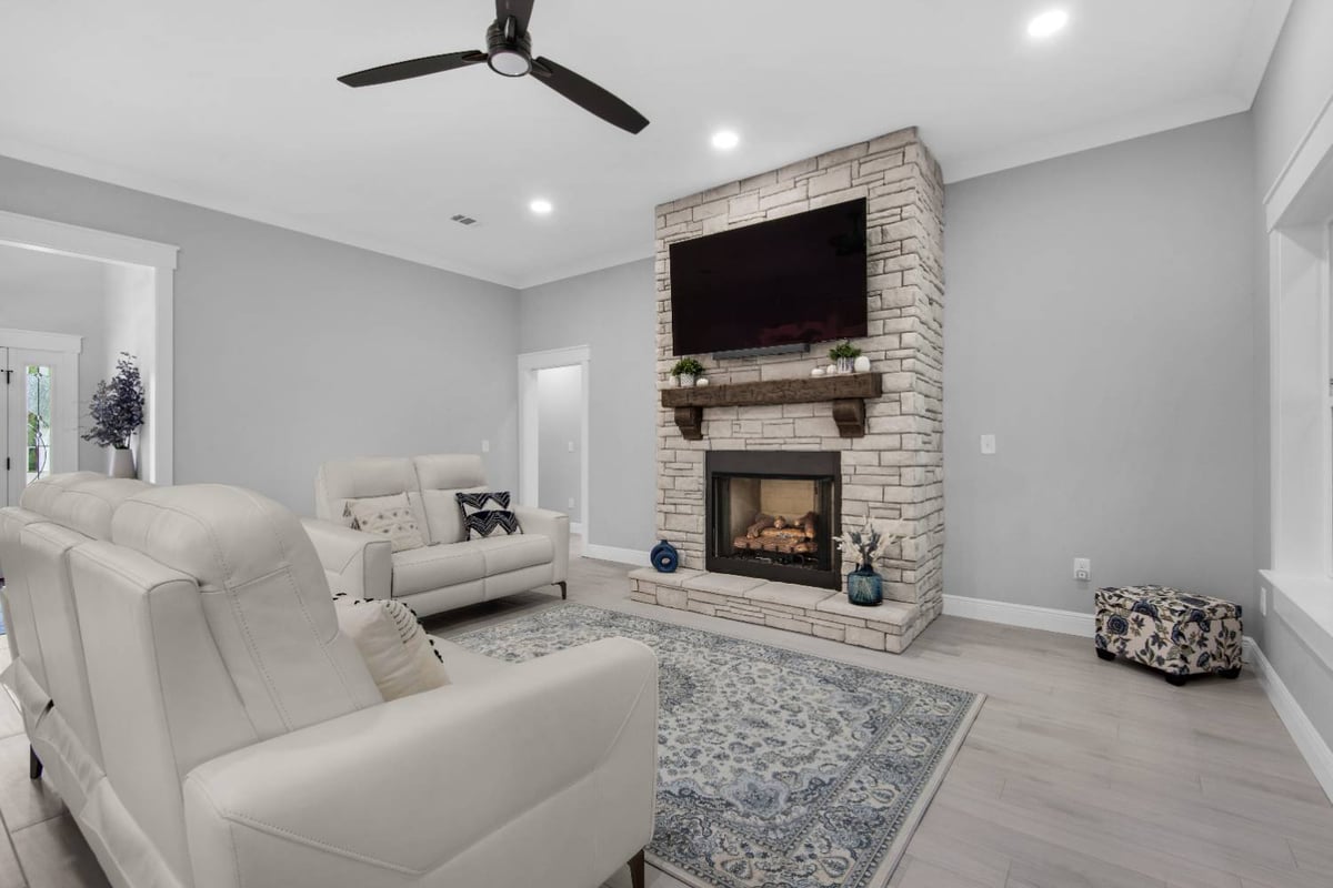 living room with white seating and stone fireplace by EZ Modern Homes Pensacola FL The Lafon-optimized